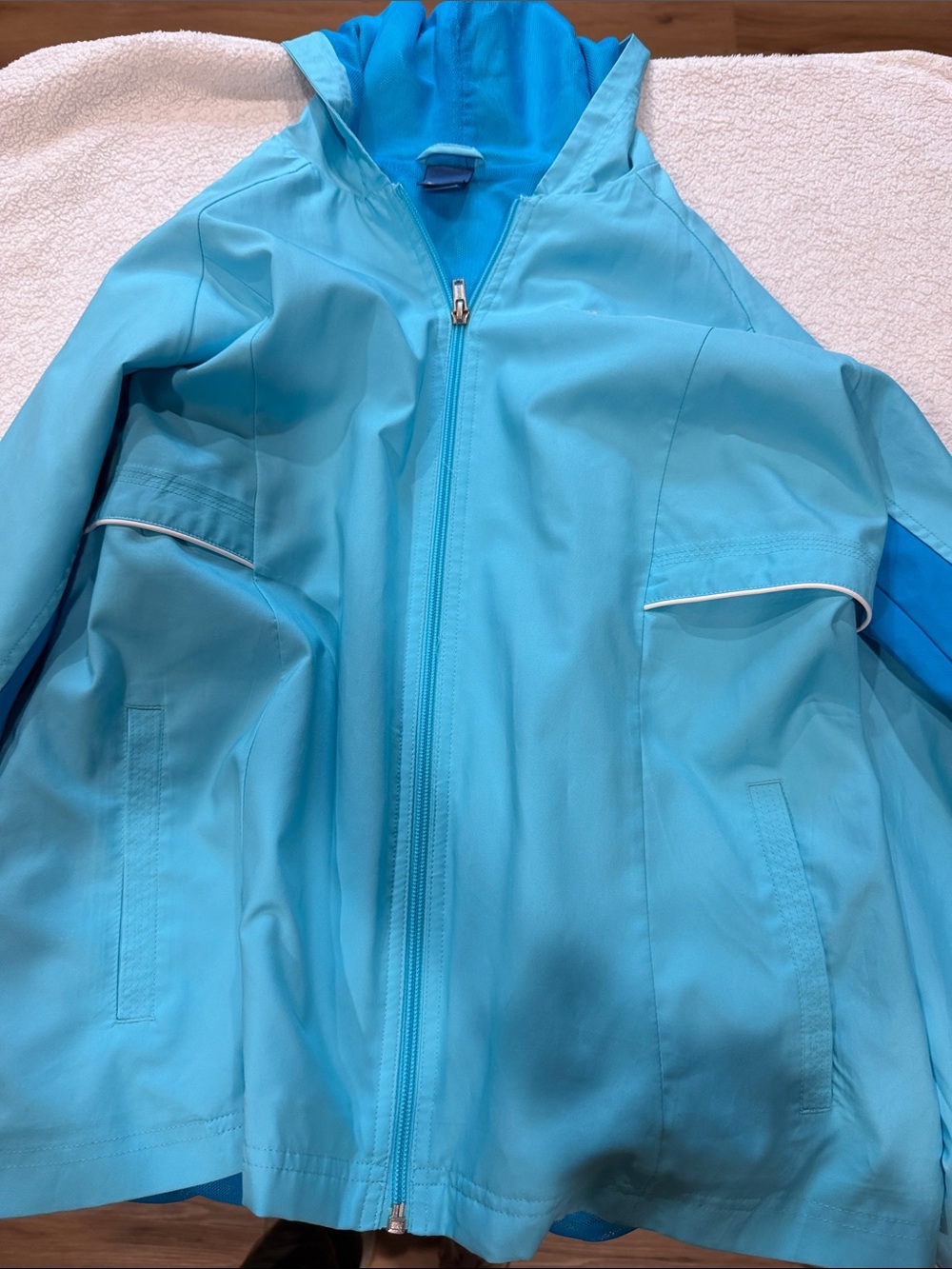 Reebok women’s Bright Aqua Hooded Raincoat